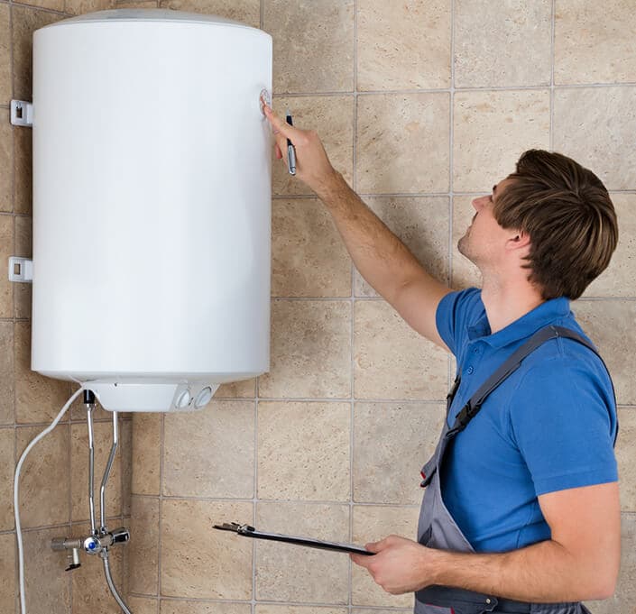 Technician inspecting a water heater