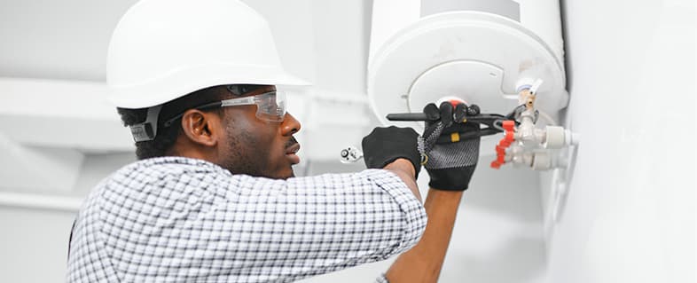 Technician repairing a water heater