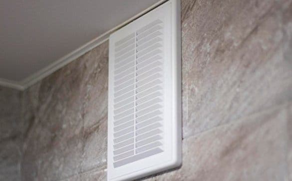 White dryer vent high up on the wall
